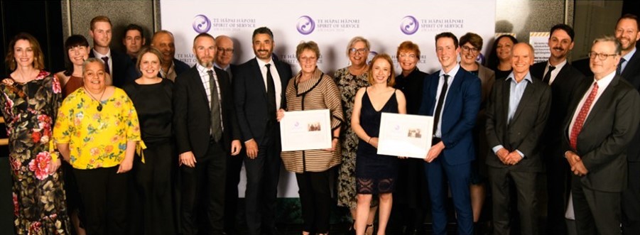 Staff from Inland Revenue, Ministry of Social Development, Ministry of Business, Innovation and Employment, and Treasury accept the e Tohu mō ngā Hua E Pai Ake Ana—Collaborative Spirit of Service Award